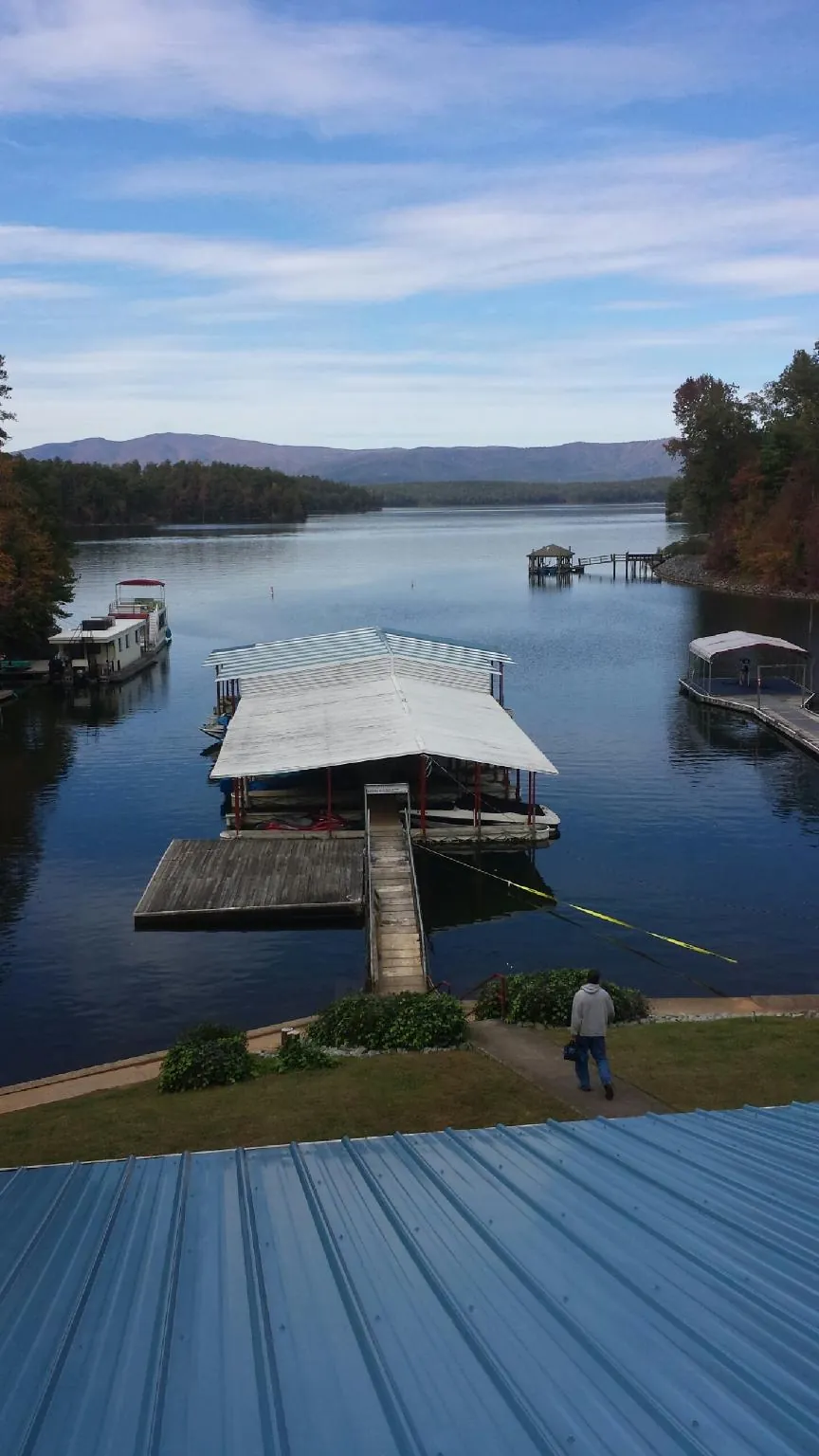 View across a lake from a newly installed blue metal roof in North Wales